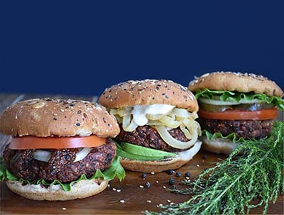 Three Burgers with onions and herbs