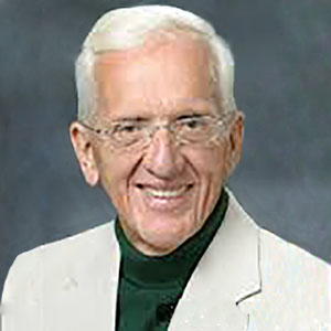 Campbell smiling and wearing white color coat